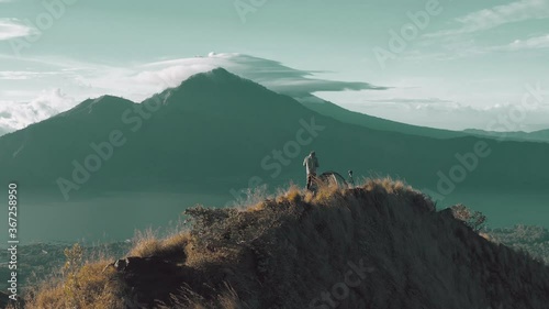 Silhouette traveler people meeting sunrise on top of active volcano Batur Kintamani. Mount Batur Sunrise Trekking photo