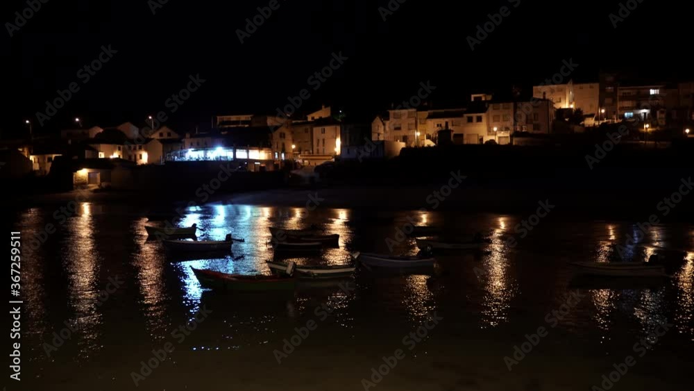 Boats Moored at night in coastal village of Galicia,Spain. Aerial Drone Video Boats Moored at night in coastal village of Galicia,Spain. Aerial Drone Video