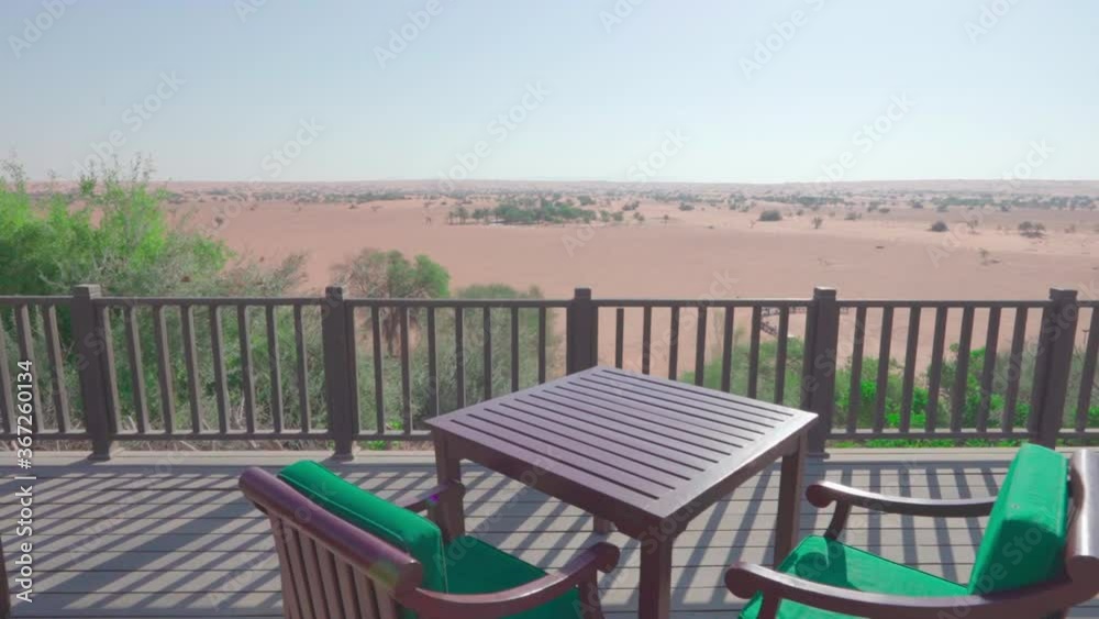 Terrace with panoram view of the desert. There are cafe tables on the terrace. Dubai, UAE. Terrace with panoram view of the desert. There are cafe tables on the terrace. Dubai, UAE.