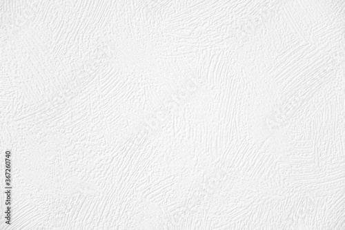Texture of white vinyl wallpaper looks like a paint strokes on wall, closeup view. Wallpaper for painting.