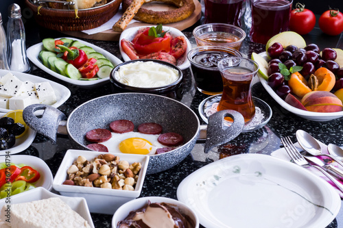 Traditional Turkish Breakfast with sausage egg pan on granite marble table.Close and large view 