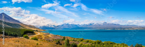 Mount Cook Highway along Lake Pukaki  one of the most spectacular alpine scenery in the world in New Zealand  South Island on a beautiful summer day with snow-capped Mount Cook engulfed in the clouds.