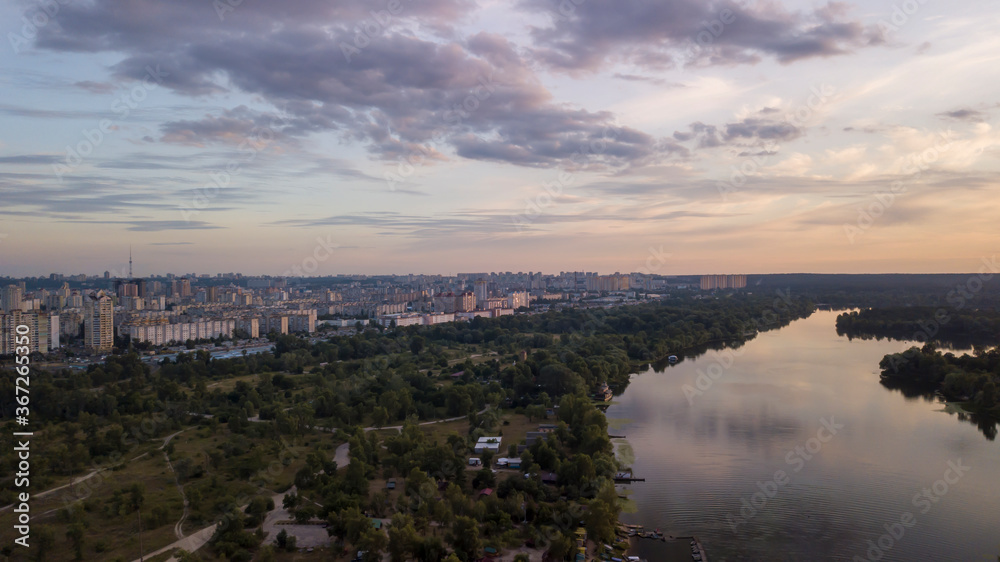 Aerial view of Kiev city with river and forest during sunset Ukraine. Beautiful sky