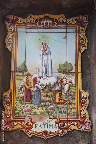 Lady of Fatima old ceramic painted tiles on a wall