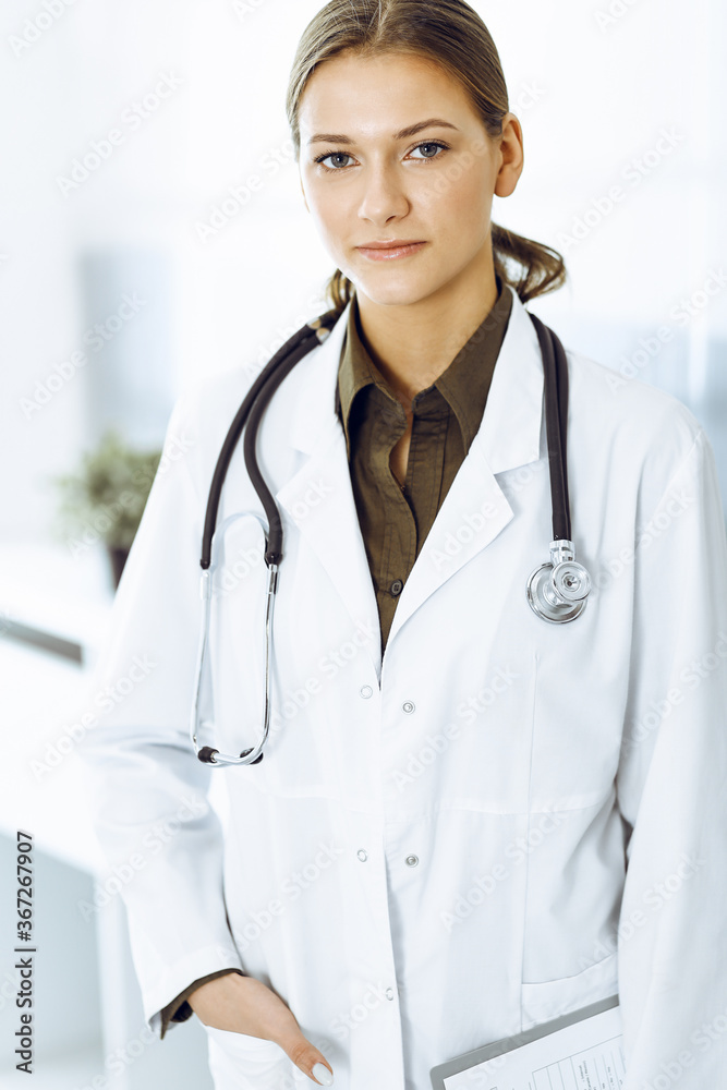 Woman-doctor standing and looking at camera. Medicine and healthcare
