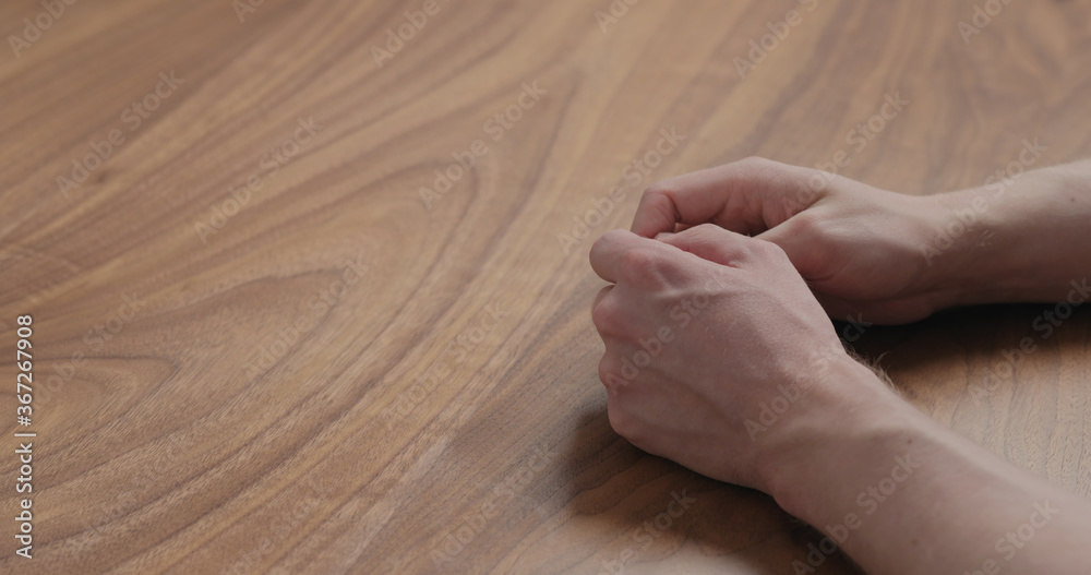 man hand waiting on black walnut table man hand waiting on black walnut table