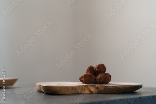 Handmade chocolate truffles on olive wwod board photo