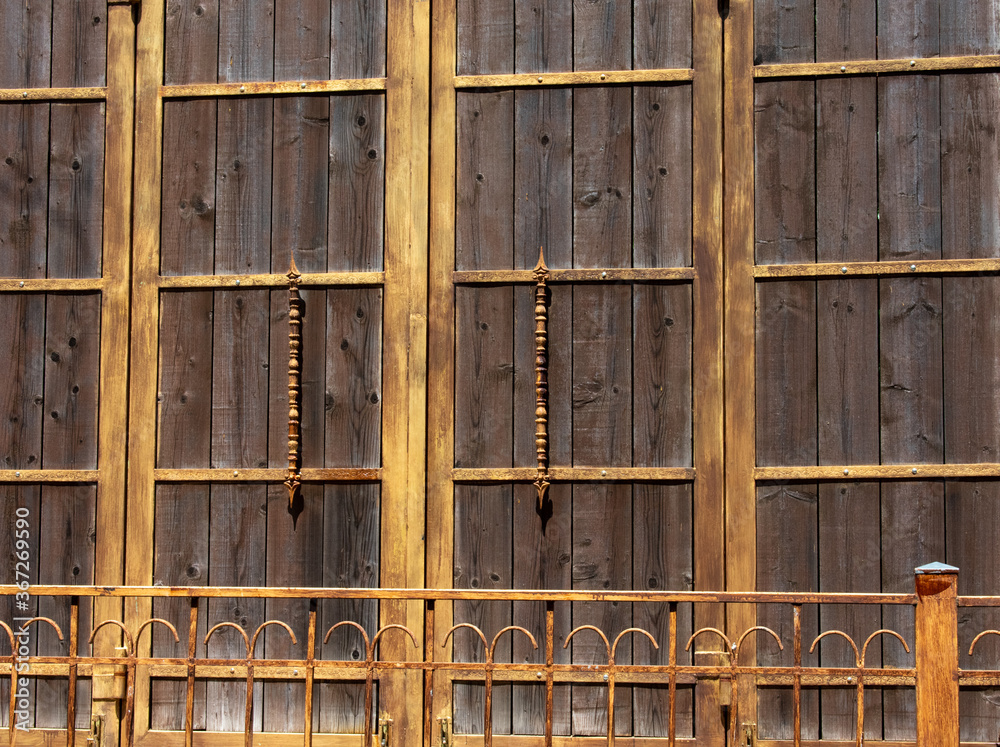 large wooden courtyard door and metal fence large wooden courtyard door and metal fence