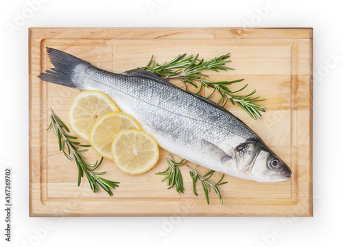 Fresh uncooked seabass with lemon and rosemary on wooden board over white backdground with clipping path