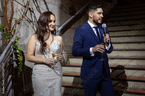 portrait of a newly married couple in the middle of a speech
