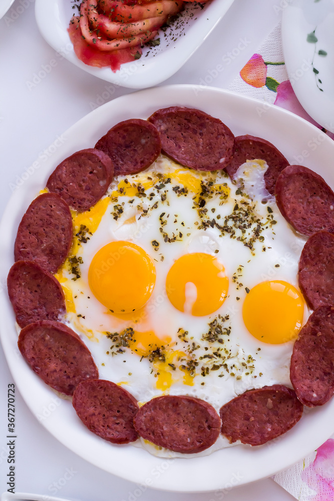 Traditional Turkish Breakfast egg with sausage on white of vertical image Traditional Turkish Breakfast egg with sausage on white of vertical image