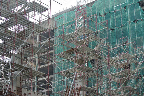 Wallpaper Mural JOHOR, MALAYSIA -APRIL 13, 2016: Scaffolding used as the temporary structure to support platform, form work and structure at the construction site. Also used it as a walking platform for workers.  Torontodigital.ca
