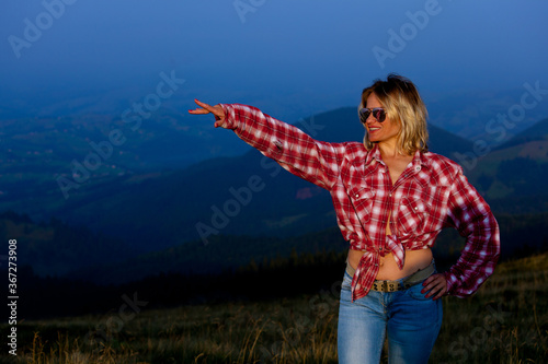 girl posing against the backdrop of a mountain © Farik