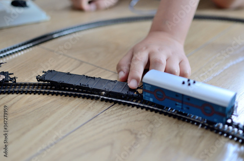 Toy train with child's hand