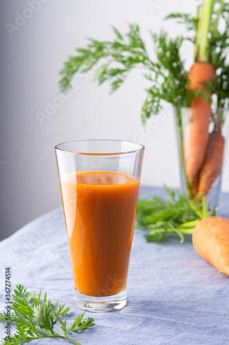 Natural carrot juice with pulp sugar-free in glasses on a table with a blue tablecloth