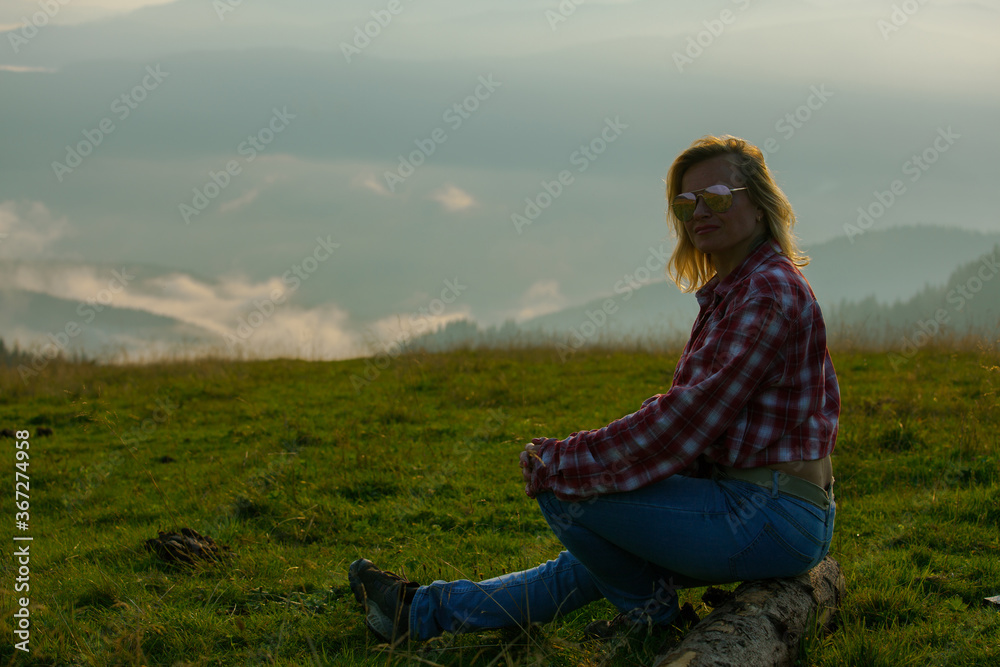 blonde woman in the foggy mountains