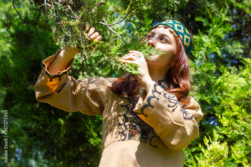 Armenian young woman in traditional clothes in the forest 