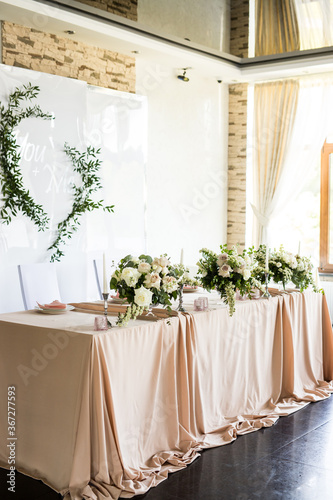 Side view of the presidium with fresh flowers of the newlyweds at the wedding