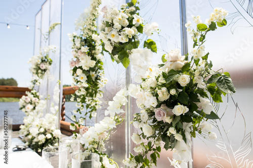Close up of wedding decor with white transparent screens and fresh white flowers