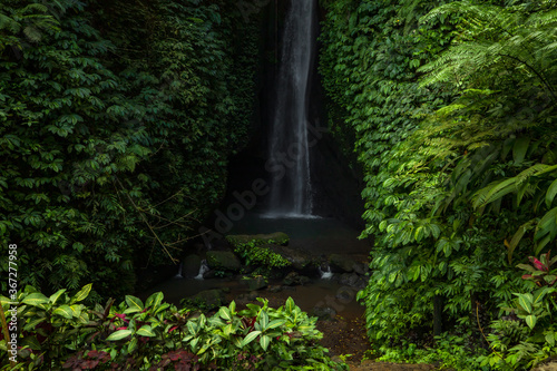 Waterfall landscape. Beautiful hidden Leke Leke waterfall in Bali. Waterfall in tropical rainforest. Slow shutter speed, motion photography.