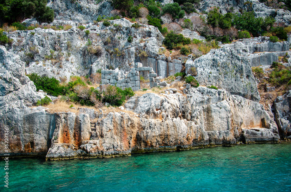Ruins of the ancient sunken Lycian underwater city of Dolichiste on the island of Kekova. Attraction of the Mediterranean sea under water. Sea tour near Demre and Semena. Antalya Province, Turkey.