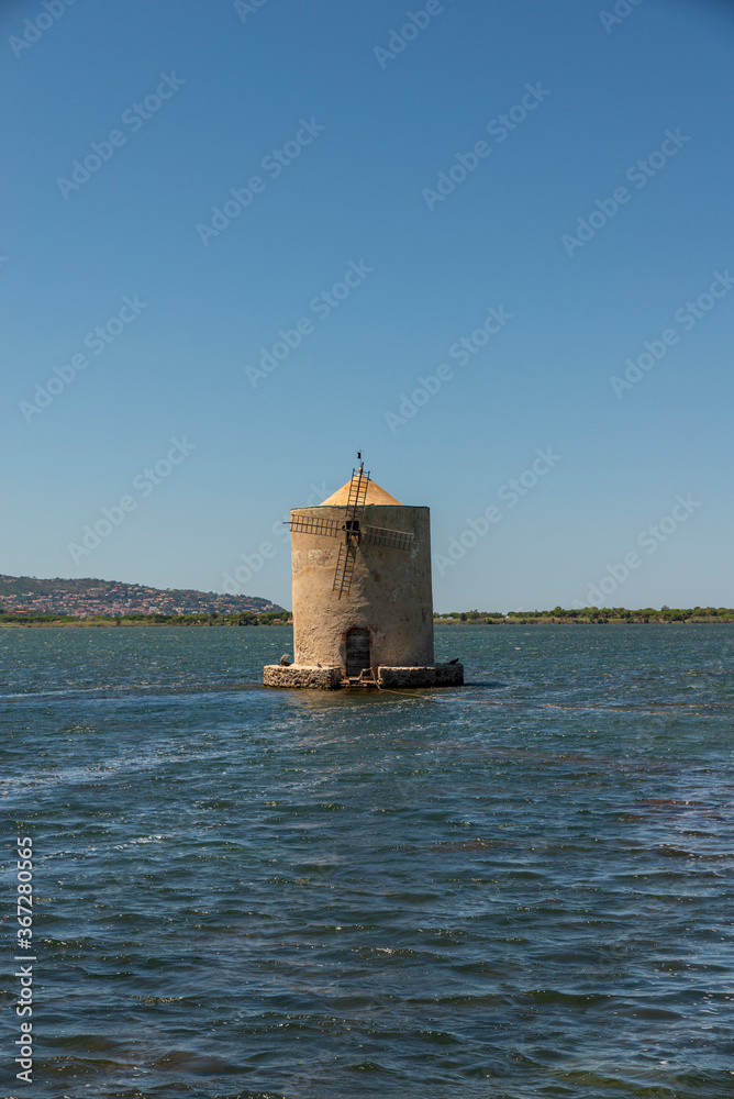old windmill in the middle of the sea in orbetello