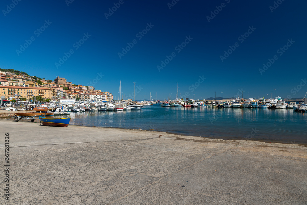 quay where boats go to sea in porto santo stefano