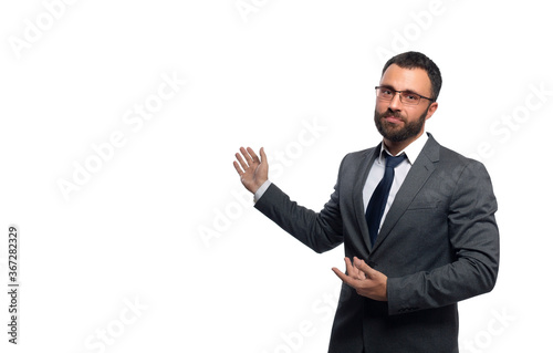 Businessman in glasses with a beard looks at the camera pointing with his hands to the side, a photograph of the waist
