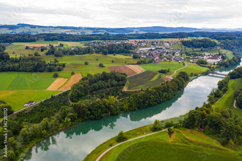 Aerial view of river landscape with green meadows and fields