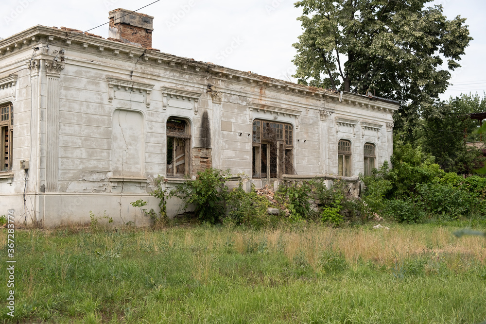Old house with a unique design in baroque style in Romania abandoned and allowed to grow grass next to it owner Dimitrie Razlet
