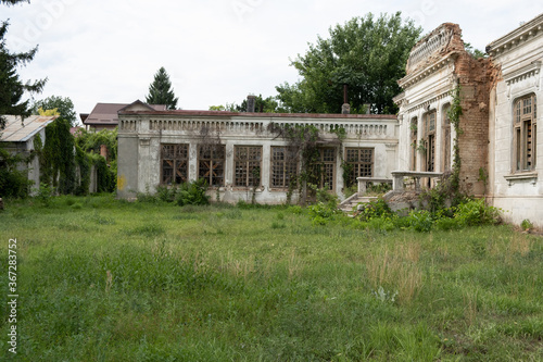 Old house with a unique design in baroque style in Romania abandoned and allowed to grow grass next to it owner Dimitrie Razlet
 photo