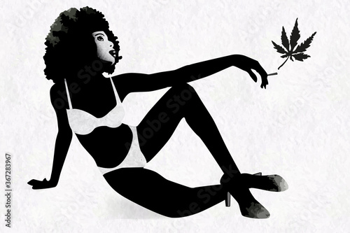 Woman's silhouette with afro hairstyle holding marijhuana leaf in her hand