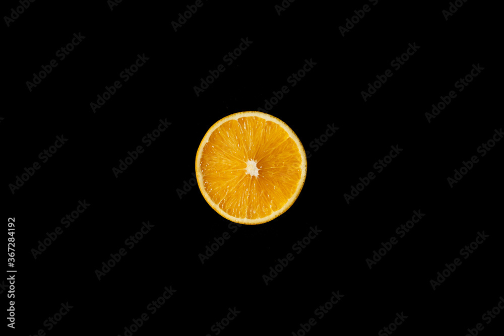 Orange cut in half, one light source, on black background