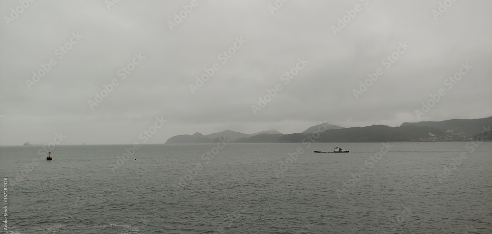 The sea of Yeosu, South Korea. A ship passing through the sea fog.
