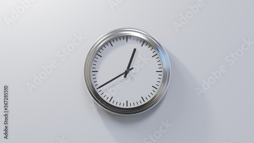 Glossy chrome clock on a white wall at twenty to one. Time is 00:40 or 12:40