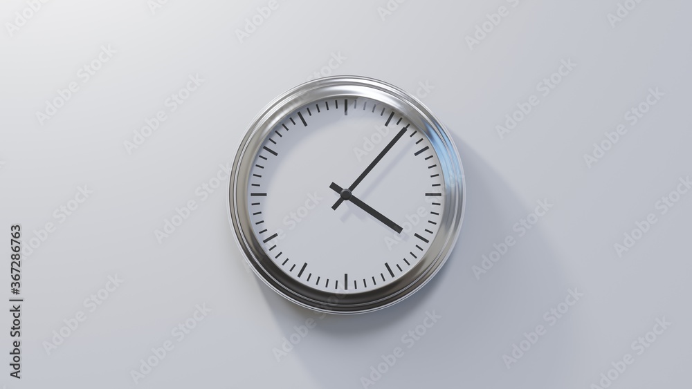 Glossy chrome clock on a white wall at seven past four. Time is 04:07 or 16:07 Glossy chrome clock on a white wall at seven past four. Time is 04:07 or 16:07