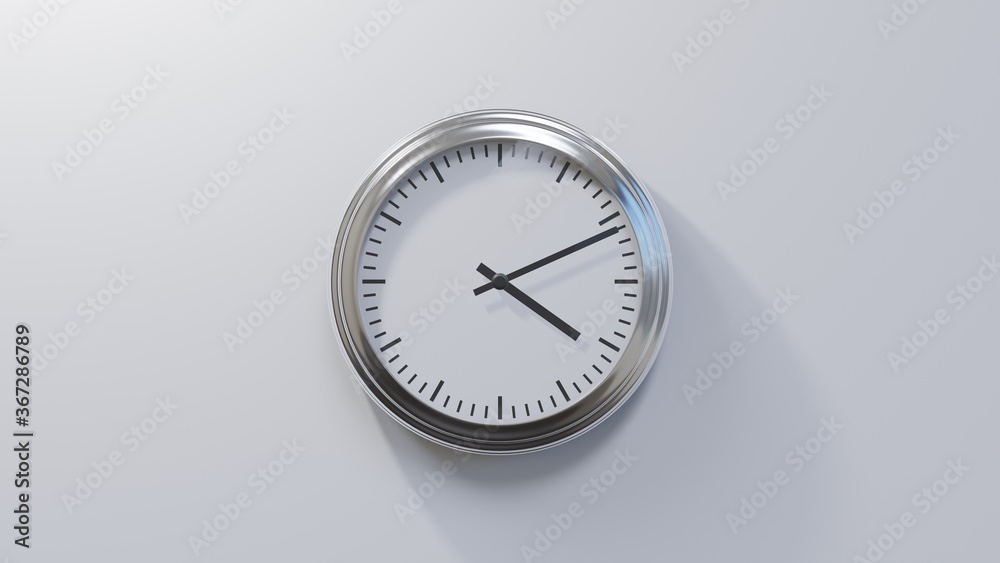 Glossy chrome clock on a white wall at eleven past four. Time is 04:11 or 16:11 Glossy chrome clock on a white wall at eleven past four. Time is 04:11 or 16:11