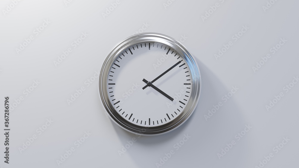 Glossy chrome clock on a white wall at nine past four. Time is 04:09 or 16:09 Glossy chrome clock on a white wall at nine past four. Time is 04:09 or 16:09