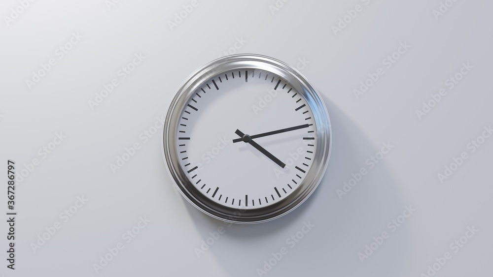 Glossy chrome clock on a white wall at thirteen past four. Time is 04:13 or 16:13 Glossy chrome clock on a white wall at thirteen past four. Time is 04:13 or 16:13