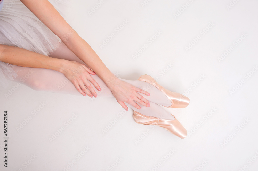 Fototapeta premium Young beautiful ballerina dances in big studio isolated on white background