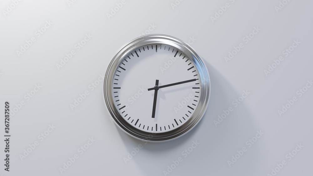 Glossy chrome clock on a white wall at thirteen past six. Time is 06:13 or 18:13