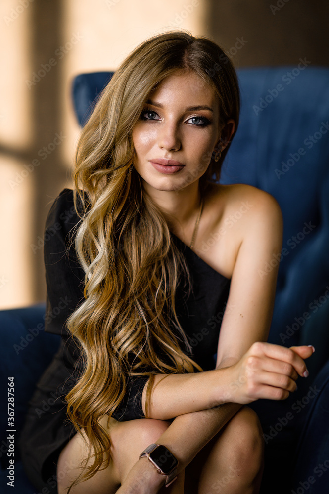 Beautiful brown-haired woman in a black dress. Portrait Beautiful brown-haired woman in a black dress. Portrait