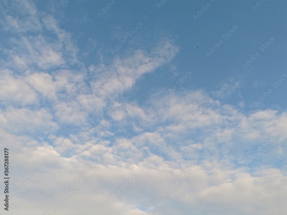 white clouds against a blue sky background