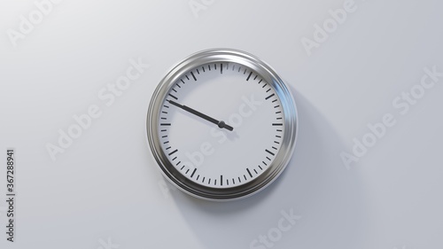 Glossy chrome clock on a white wall at forty-nine past nine. Time is 09:49 or 21:49 photo