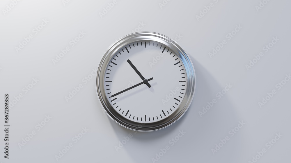 Glossy chrome clock on a white wall at forty-one past ten. Time is 10:41 or 22:41