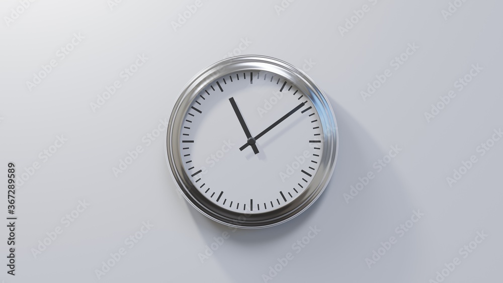 Glossy chrome clock on a white wall at nine past eleven. Time is 11:09 or 23:09 Glossy chrome clock on a white wall at nine past eleven. Time is 11:09 or 23:09