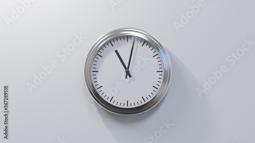 Glossy chrome clock on a white wall at two past eleven. Time is 11:02 or 23:02