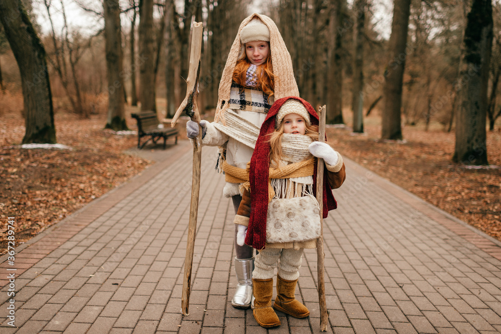 Two little girls decided to go on a long hike in the cold autumn and took with them all the necessary things
