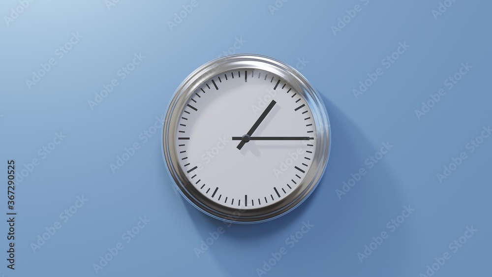 Glossy chrome clock on a blue wall at quarter past one. Time is 01:15 or 13:15