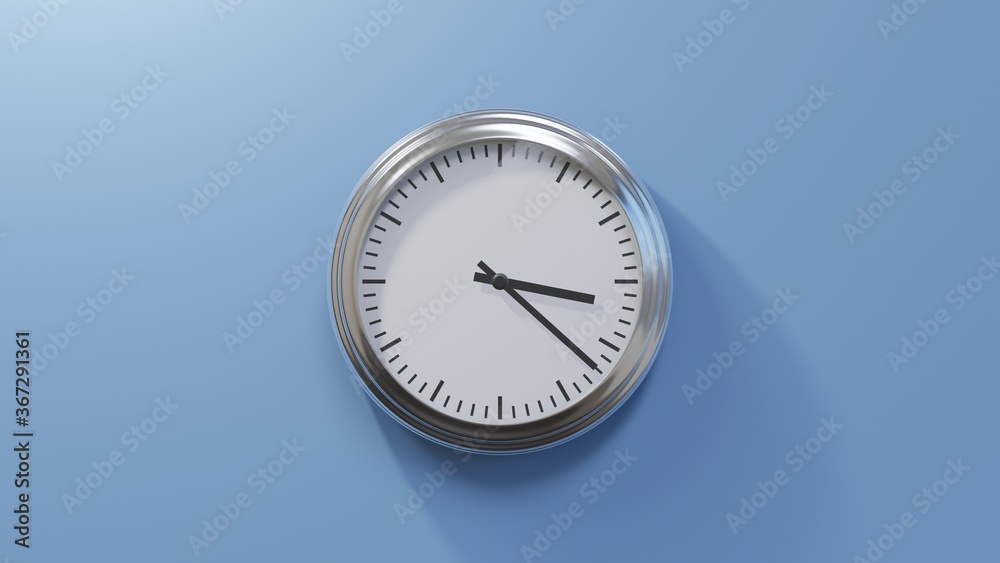 Glossy chrome clock on a blue wall at twenty-two past three. Time is 03:22 or 15:22 Glossy chrome clock on a blue wall at twenty-two past three. Time is 03:22 or 15:22